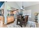 Cozy dining area with rustic wood table, modern lighting, and a view of the kitchen at 10360 Irving Ct, Westminster, CO 80031