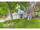 Charming home with a well-manicured lawn, mature trees, and a cozy covered front porch at 10360 Irving Ct, Westminster, CO 80031