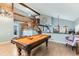 Open game room with a pool table, hardwood floors, and view of staircase at 10360 Irving Ct, Westminster, CO 80031