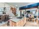 Open kitchen with an island, updated appliances, and connected dining area with staircase view at 10360 Irving Ct, Westminster, CO 80031