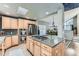 Well-lit kitchen with a center island, stainless appliances, and view of the dining area at 10360 Irving Ct, Westminster, CO 80031