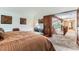 Bright main bedroom with a high ceiling, carpet floors, and a rustic wooden sliding door closet at 10360 Irving Ct, Westminster, CO 80031