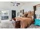 Comfortable main bedroom with a unique headboard, ceiling fan, and access to the en-suite bathroom at 10360 Irving Ct, Westminster, CO 80031