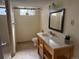 Bright bathroom features shower, toilet and wood vanity at 6095 W 47Th Ave, Wheat Ridge, CO 80033