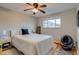 Comfortable bedroom featuring hardwood floors, a ceiling fan, and a cozy bed with a padded headboard at 6095 W 47Th Ave, Wheat Ridge, CO 80033