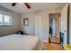Inviting bedroom with hardwood floors, a ceiling fan, closet, and a view to other rooms, creating a comfortable space at 6095 W 47Th Ave, Wheat Ridge, CO 80033