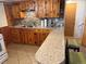 Basement kitchen features tile floors, wooden cabinets and eat-in bar at 6095 W 47Th Ave, Wheat Ridge, CO 80033