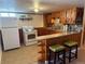 Basement kitchen features tile floors, wooden cabinets and eat-in bar at 6095 W 47Th Ave, Wheat Ridge, CO 80033