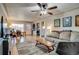 Bright living room with hardwood floors, a ceiling fan and a view of the front entrance and dining area at 6095 W 47Th Ave, Wheat Ridge, CO 80033