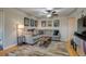 Comfortable living room with modern fan, hardwood floors, and a large sectional with unique artwork at 6095 W 47Th Ave, Wheat Ridge, CO 80033