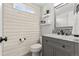 Updated bathroom with wood-look tile floor and modern vanity at 5418 S Fundy Cir, Centennial, CO 80015