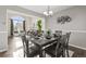 Bright dining room with table set for four, offering views into the living room at 5418 S Fundy Cir, Centennial, CO 80015