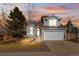 Two-story house with attached garage and landscaped yard at 5418 S Fundy Cir, Centennial, CO 80015