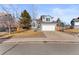 Two-story house with gray siding, attached garage, and basketball hoop at 5418 S Fundy Cir, Centennial, CO 80015