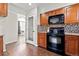 Kitchen with black appliances and wood cabinets at 5418 S Fundy Cir, Centennial, CO 80015