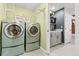 Main floor laundry room with two sets of washer and dryer at 5418 S Fundy Cir, Centennial, CO 80015