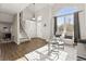 Living room with hardwood floors, large windows, and access to the staircase at 5418 S Fundy Cir, Centennial, CO 80015