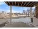 Covered back patio overlooking a winter wonderland, perfect for relaxing at 5591 Canyon View Dr, Castle Rock, CO 80104
