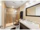 Well-lit bathroom featuring a glass shower, modern vanity, and stylish fixtures at 5591 Canyon View Dr, Castle Rock, CO 80104