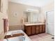 Relaxing bathroom features a soaking tub, double sinks, and a large mirror with good lighting at 5591 Canyon View Dr, Castle Rock, CO 80104