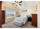 Comfortable bedroom featuring a queen-size bed, a ceiling fan, and a large window with a view at 5591 Canyon View Dr, Castle Rock, CO 80104