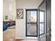 Inviting entryway opening to a bright living space, featuring a stylish screen door and views of the outdoor deck at 5591 Canyon View Dr, Castle Rock, CO 80104