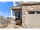 Welcoming front door featuring stone accents and well-manicured landscaping, enhancing the home's curb appeal at 5591 Canyon View Dr, Castle Rock, CO 80104