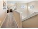 Hallway with carpet, neutral walls, pictures, and views of the exterior through windows at 5591 Canyon View Dr, Castle Rock, CO 80104