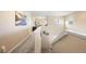 Bright hallway with neutral-colored walls, carpeted floors, and a staircase leading to another floor at 5591 Canyon View Dr, Castle Rock, CO 80104