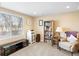 Bright living room with a large window, bookshelf, and comfortable seating area at 5591 Canyon View Dr, Castle Rock, CO 80104