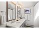 Bright bathroom features a double sink vanity with granite countertop and framed mirrors at 6 Blue Grouse Ridge Rd, Littleton, CO 80127
