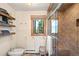 Tiled bathroom with natural light, shower, and storage at 6 Blue Grouse Ridge Rd, Littleton, CO 80127