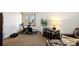 A functional room featuring carpeted floors, a stationary bike, weights, and an armchair at 6 Blue Grouse Ridge Rd, Littleton, CO 80127