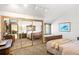 Well-lit bedroom featuring carpeted floors, a mirrored closet, and a cozy window seat at 6 Blue Grouse Ridge Rd, Littleton, CO 80127