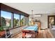Game room with a pool table, piano, and large windows offering scenic views at 6 Blue Grouse Ridge Rd, Littleton, CO 80127