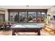 Spacious game room features a pool table, piano, and scenic mountain views through large windows at 6 Blue Grouse Ridge Rd, Littleton, CO 80127