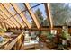 Spacious indoor atrium with natural light, comfortable seating, and scenic views at 6 Blue Grouse Ridge Rd, Littleton, CO 80127