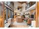 Open-concept living room with a stone fireplace, hardwood floors, and loft access at 6 Blue Grouse Ridge Rd, Littleton, CO 80127