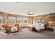 Warm and inviting bedroom with wood accent wall and scenic views at 6 Blue Grouse Ridge Rd, Littleton, CO 80127