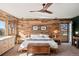 This main bedroom boasts a wood accent wall, ceiling fan and balcony access at 6 Blue Grouse Ridge Rd, Littleton, CO 80127