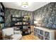 Cozy home office with patterned wallpaper and ample storage space at 6 Blue Grouse Ridge Rd, Littleton, CO 80127