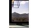 Picturesque mountain view framed by a window, showcasing the home's beautiful surroundings at 6 Blue Grouse Ridge Rd, Littleton, CO 80127
