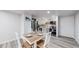 Dining area features wood table and chairs, alongside stainless steel appliances in the kitchen at 8826 E Florida Ave # G12, Denver, CO 80247