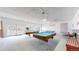 Spacious game room with pool tables and natural light, perfect for entertainment at 8826 E Florida Ave # G12, Denver, CO 80247