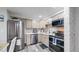 Bright kitchen with stainless steel appliances, light cabinetry, and a modern tile backsplash at 8826 E Florida Ave # G12, Denver, CO 80247