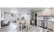 Open-concept living area with a dining table, stainless steel appliances, and a stylish stone accent wall at 8826 E Florida Ave # G12, Denver, CO 80247