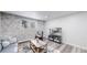 Cozy living room featuring a stone accent wall, large window, and modern decor at 8826 E Florida Ave # G12, Denver, CO 80247