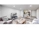 Open-concept living room with stone wall, seamlessly integrates dining and kitchen areas at 8826 E Florida Ave # G12, Denver, CO 80247