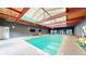 Indoor pool with skylights and exposed beams for a unique recreational experience at 8826 E Florida Ave # G12, Denver, CO 80247