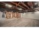 Spacious basement with exposed ceiling beams, modern flooring, and industrial style at 3019 Meade St, Denver, CO 80211